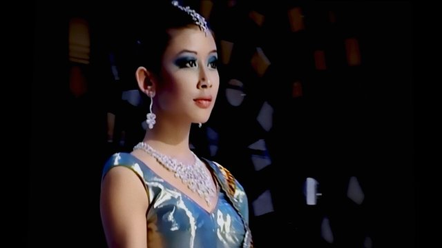 Video Reference: woman, formal wear, jewelry, makeup, portrait, stage, dark background, elegant, event, beauty