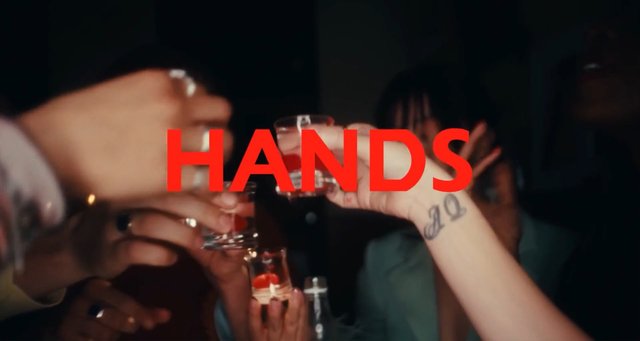 Video Reference: toast, drinks, hands, glasses, party, nightlife, celebration, closeup, group, dark, text overlay, alcohol, social, clinking, interior