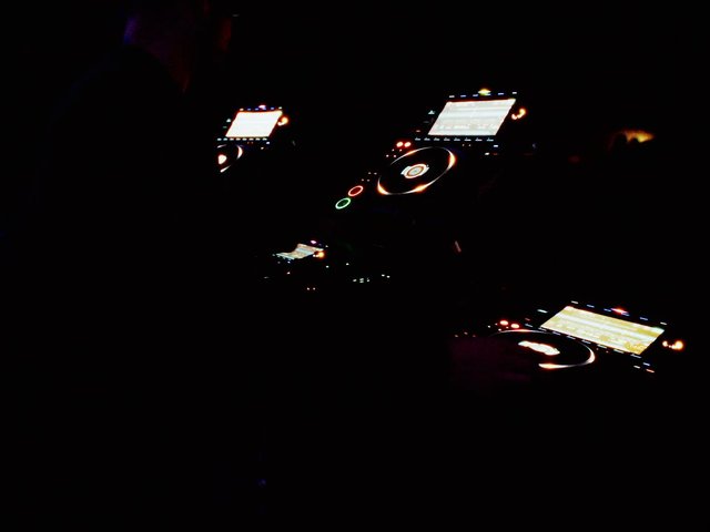 Video Reference: DJ, turntable, mixer, music, club, night, electronic, controls, screens, lighting, audio, performance, equipment, dark, dance