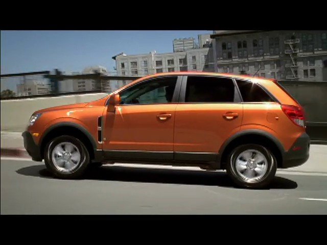 Video Reference: SUV, car, orange, driving, road, city, urban, vehicle, transportation, motion, side view, outdoor, buildings