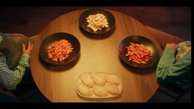 Video Reference: food, pasta, table, dining, top-down, meal, bread, plates, home, people, overhead, lunch, dinner, family, indoor