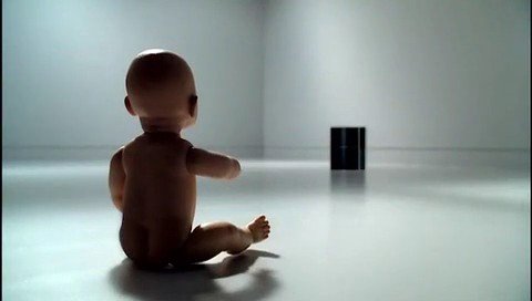 Video Reference: baby doll, toy, minimal room, white floor, cylindrical object, indoors, isolated subject, glossy surface, rear view, simple background
