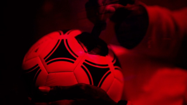 Video Reference: Sports equipment, Mouth, Football, Ball, Orange, Art, Tints and shades, Soccer ball, Fictional character, Personal protective equipment