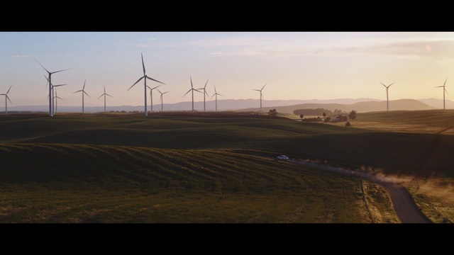 Video Reference: Windmill, Sky, Atmosphere, Ecoregion, Wind farm, Light, Nature, Black, Natural environment, Wind turbine