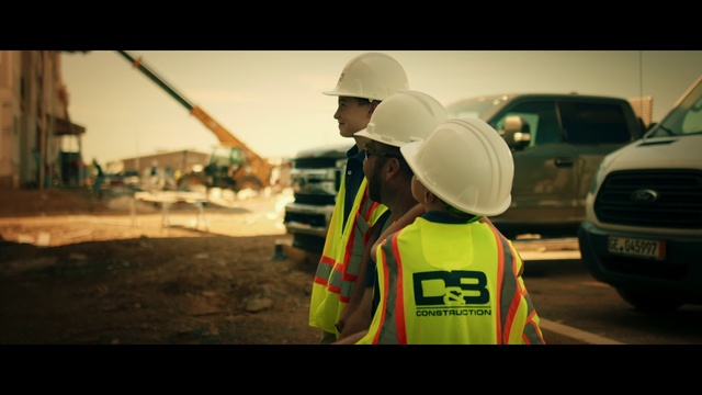 Video Reference: Car, High-visibility clothing, Hard hat, Helmet, Automotive lighting, Motor vehicle, Workwear, Vehicle, Asphalt, Flash photography