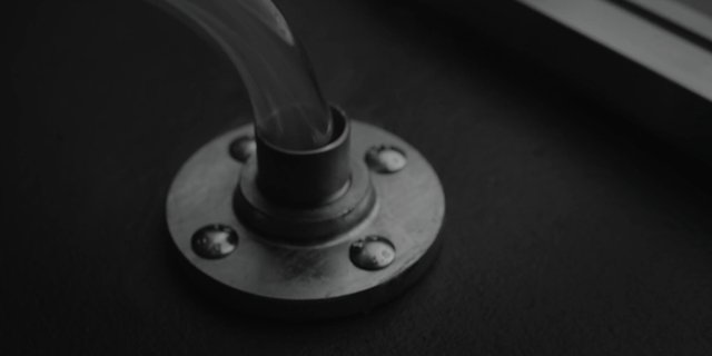 Video Reference: close-up, metal, pipe, flange, screws, industrial, hardware, monochrome, black and white, mount, base, surface, detail, macro, mechanical