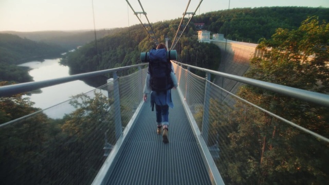 Video Reference: Water, Sky, Shorts, Tree, Leisure, Plant, Bridge, Recreation, Suspension bridge, Lake