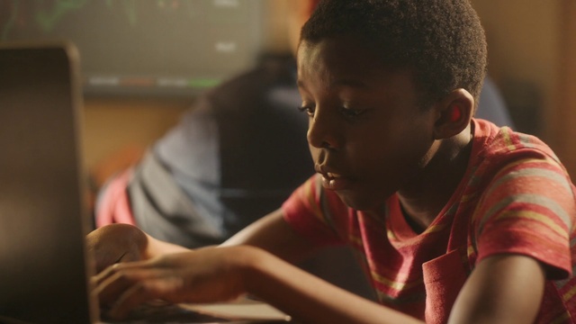 Video Reference: T-shirt, Office equipment, Recreation, Child, Event, Homework, Fun, Sitting, Room, Reading