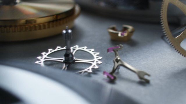 Video Reference: mechanical watch, watch movement, gears, springs, horology, timepiece, metal parts, close-up, macro, precision, engineering, luxury, mechanism, repair, craftsmanship