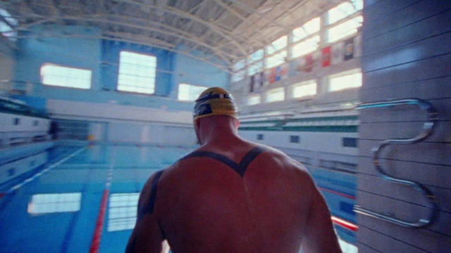 Video Reference: Swimming pool, Water, Cap, Swimmer, Headgear, Leisure, Chest, Recreation, Personal protective equipment, Electric blue