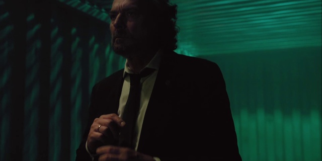 Video Reference: Green, Gesture, Dress shirt, Tie, Spokesperson, Audio equipment, Suit, Blazer, Formal wear, Event