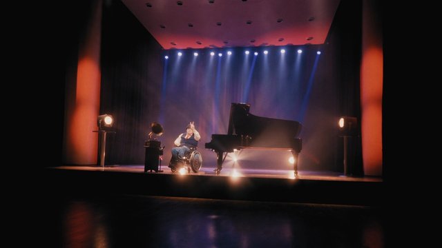 Video Reference: stage, performance, piano, grand piano, spotlights, theater, wheelchair, music, concert, stage lights, haze, curtain, spotlight, auditorium