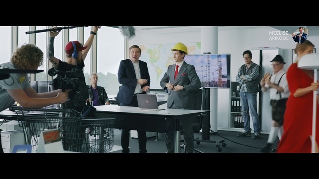 Video Reference: Shirt, Table, Hat, Suit, Fedora, Laptop, Chair, Event, Stage equipment, White-collar worker