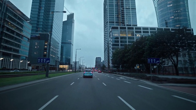 Video Reference: Skyscraper, Building, Sky, Daytime, Vehicle, Car, Infrastructure, Road surface, Cloud, Asphalt