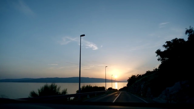 Video Reference: Sky, Cloud, Street light, Water, Afterglow, Dusk, Sunlight, Tree, Body of water, Road surface