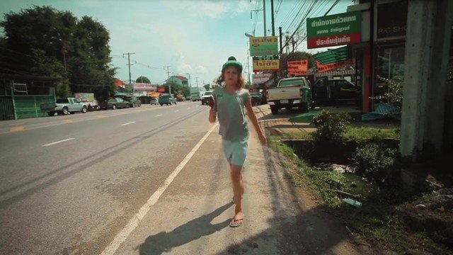Video Reference: street, roadside, person, walking, urban, daytime, storefronts, vehicles, sidewalk, outdoor, travel, suburban, signs, power-lines