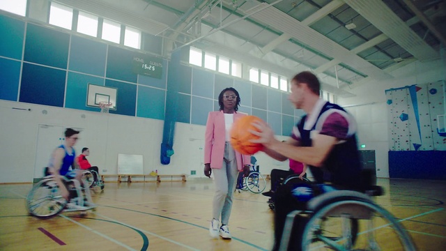 Video Reference: Wheel, Shorts, Wheelchair sports, Wheelchair, Tire, Sports uniform, Field house, Basketball, Disabled sports, Sports equipment