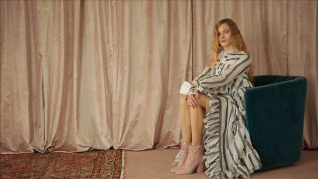 Video Reference: shoulder, outerwear, dress, fashion, textile, girl, gown, flooring, fashion design, photo shoot, Person