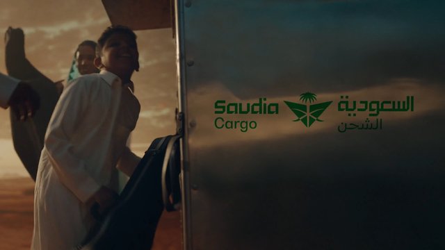 Video Reference: cargo, vehicle, logistics, shipping, delivery, transport, sunset, outdoor, person, Arabian, Arabic text, truck, freight, industrial, travel, brand logo