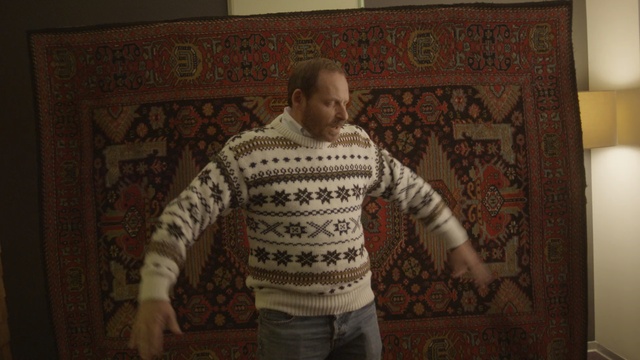 Video Reference: textile, facial hair, flooring, outerwear, pattern, art, floor, Person