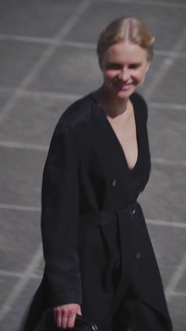 Video Reference: Clothing, Outerwear, Fashion, Standing, Coat, Formal wear, Blond, Sleeve, Suit, Neck