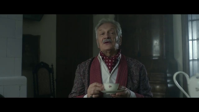 Video Reference: Facial expression, Public speaking, Speech, Head, Lady, Facial hair, Skin, Human, Screenshot, Gentleman, Person, Indoor, Man, Woman, Table, Front, Holding, Wearing, Looking, Red, Standing, Sitting, Suit, Smiling, Shirt, Young, Cake, Kitchen, White, Human face, Clothing, Portrait