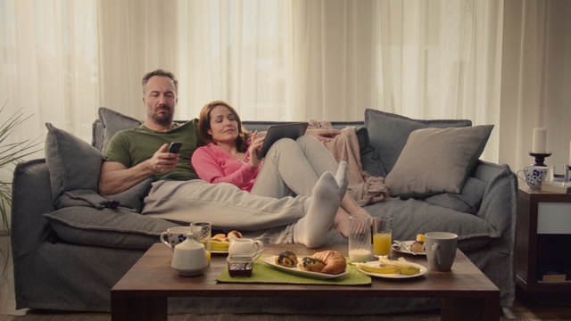 Video Reference: furniture, couch, room, interior design, home, table, living room, conversation, Person