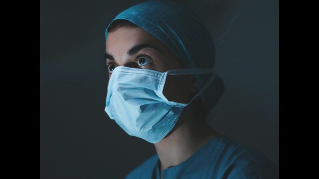 Video Reference: Face, Scrubs, Surgeon, Blue, Nose, Head, Medical equipment, Medical, Eye, Chin