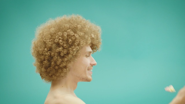 Video Reference: Hair, Hairstyle, Chin, Head, Afro, Blond, Wig, Neck, Smile