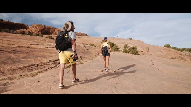 Video Reference: mountainous landforms, wilderness, badlands, sand, sky, vacation, adventure, landscape, rock, walking, Person