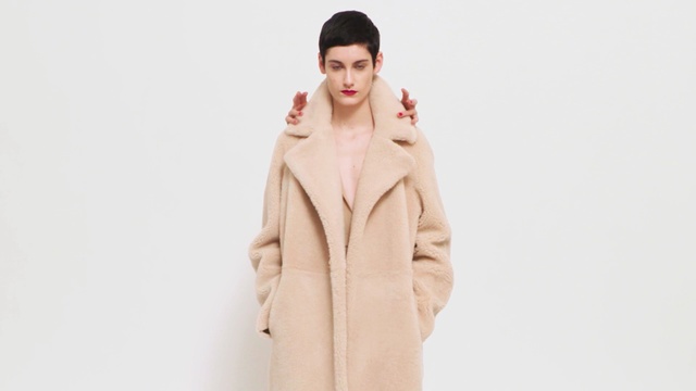 Video Reference: fashion model, coat, fur clothing, fashion, outerwear, model, fur, neck, overcoat, peach, Person