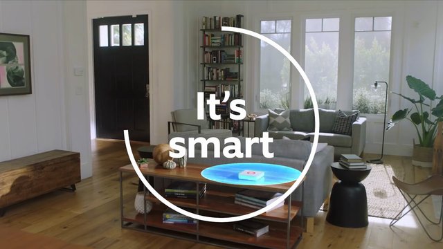 Video Reference: living room, interior, modern home, sofa, coffee table, bookshelf, windows, sunlight, decor, home staging, text overlay, graphic overlay, smart home, residential, furniture