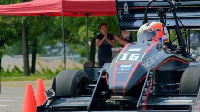 Video Reference: car, formula racing, formula one car, race track, formula one, open wheel car, racing, auto racing, motorsport, vehicle, Person