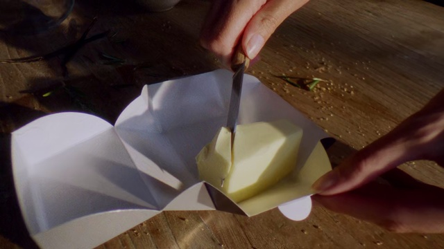 Video Reference: Paper, Food, Dairy, Table, Cutting, Indoor, Knife, Board, Piece, Wooden, Cut, Cake, Sitting, Chocolate, Using, Plate, Sandwich, Cheese, Hot, White, Pizza