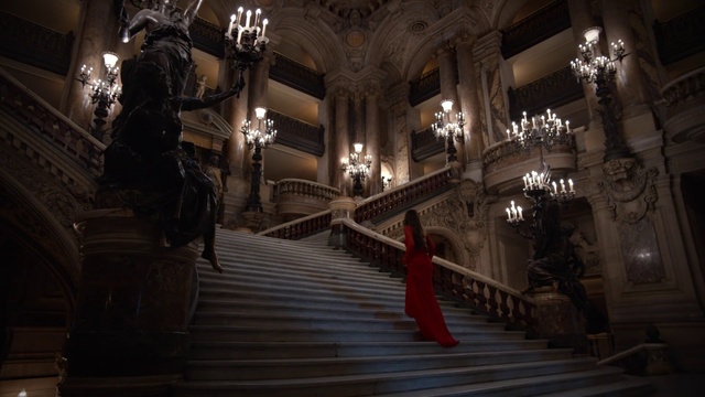 Video Reference: Building, Architecture, Photography, Darkness, Stairs, Indoor, Room, Clock, Man, Front, Sitting, Standing, Large, Red, Night, Lit, Light, Table, Woman, Walking, Holding, White, Fire, Clothing, Person