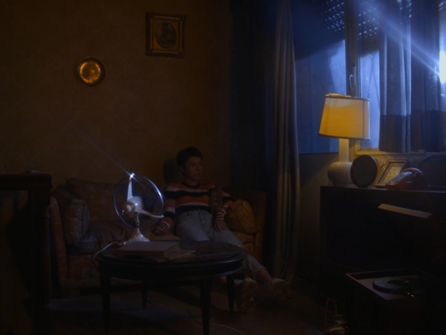 Video Reference: room, darkness, light, lighting, table, night, interior design, light fixture, house, midnight, Person