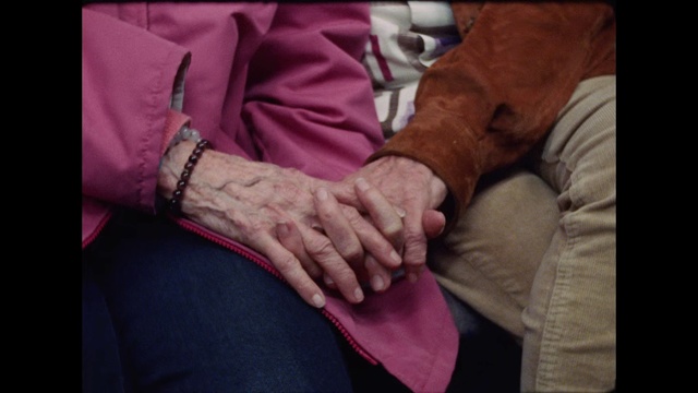 Video Reference: Finger, Hand, Pink, Interaction, Arm, Gesture, Human, Wrist, Joint, Flesh, Person, Indoor, Sitting, Small, Little, Man, Child, Holding, Wearing, Young, Boy, Suit, Table, Standing, Woman, Playing, Red, Shirt, Purple, Phone, Bed, Fashion accessory, Clothing