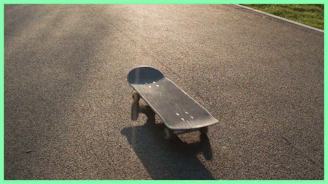 Video Reference: Skateboard, Skateboarding equipment, Longboard, Skateboarding, Sports equipment, Asphalt, Green, Small, Sitting, Game, Front, Pair, Black, Table, Computer, Desk, Standing, Laying, Young, Room, Floor