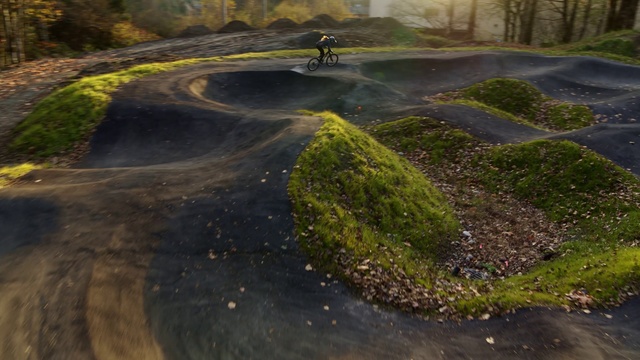 Video Reference: Grass, Soil, Asphalt, Road, Tree, Landscape, Vehicle, Geological phenomenon, Sports equipment, Freeride