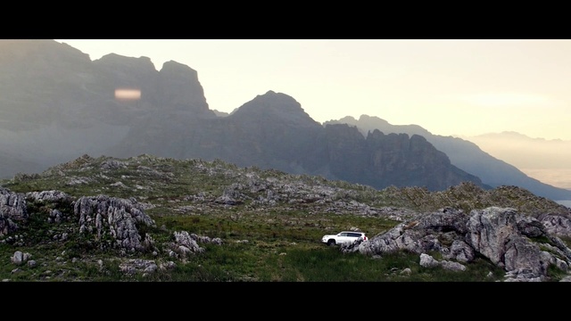 Video Reference: Sky, Mountain, Natural landscape, Highland, Slope, Bedrock, Grass, Terrain, Grassland, Landscape