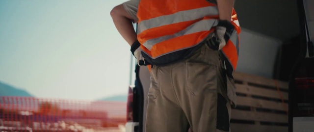 Video Reference: High-visibility clothing, Orange, Sleeve, Waist, Gesture, Bag, Workwear, Sportswear, Sports gear, Elbow