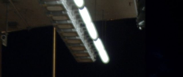 Video Reference: Light, Lighting, Stairs, Electronic instrument, Night, Darkness, Indoor, Sitting, Laptop, Computer, Dark, Front, Keyboard, White, Black, Close, Kitchen, Oven, Sign, Table, Train, Pizza, Room, Man, Stove