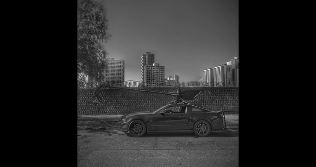 Video Reference: Black, Automotive design, Car, Sky, Vehicle, Personal luxury car, Atmospheric phenomenon, Mode of transport, Snapshot, Monochrome