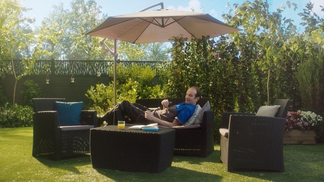 Video Reference: Umbrella, Furniture, Canopy, Wicker, Outdoor table, Shade, Patio, Table, Lawn, Grass, Person