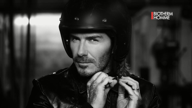 Video Reference: Helmet, Facial hair, Beard, Personal protective equipment, Black-and-white, Photography, Leather, Jacket, Moustache, Headgear, Person, Man, Building, Wearing, Holding, Hat, Young, Photo, White, Black, Cellphone, Talking, Sitting, Phone, Standing, Umbrella, Uniform, Baseball, Green, Street, Rain, City, Human face, Clothing, Black and white, Firefighter