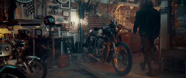 Video Reference: Vehicle, Motorcycle, Mode of transport, Car, Night, Chopper, Building, Person, Bicycle, Man, Parked, Street, Standing, Woman, Front, Sidewalk, Store, Riding, Cart, Young, City, Food, People, Table, Walking, Room, Display, Kitchen, Shop, Holding, Wheel, Tire, Land vehicle, Auto part, Bike, Scooter