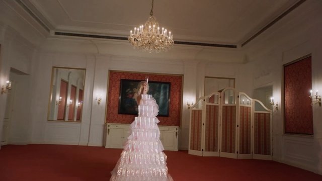 Video Reference: Dress, Gown, Photograph, Wedding dress, Bridal clothing, Room, Ceiling, Bride, Bridal accessory, Textile