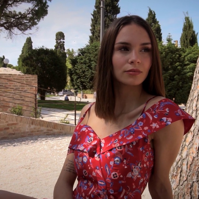 Video Reference: Hair, Shoulder, Clothing, Beauty, Lady, Summer, Joint, Lip, Long hair, Tree, Person, Outdoor, Holding, Woman, Red, Posing, Young, Smiling, Shirt, Front, Sitting, Dress, Girl, Food, Standing, Hand, Wearing, Park, Large, Man, Beach, Hot, River, Hotdog, Water, White, Pizza, Phone, Sky, Human face, Ground, Fashion accessory