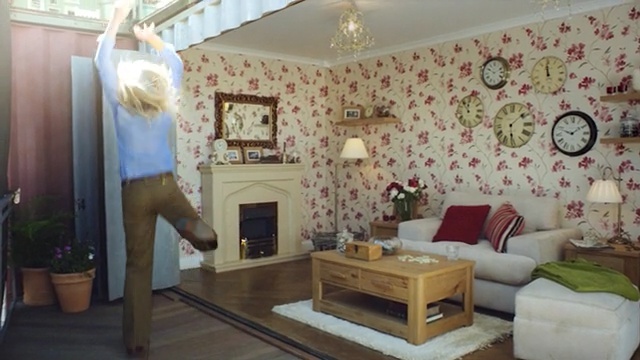 Video Reference: living room, room, property, home, interior design, wall, ceiling, house, real estate, furniture, Person