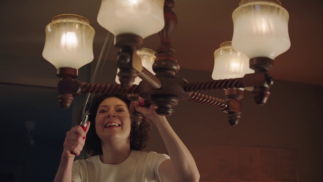 Video Reference: Light fixture, Lighting, Lamp, Lighting accessory, Incandescent light bulb, Light, Chandelier, Light bulb, Ceiling, Facial hair